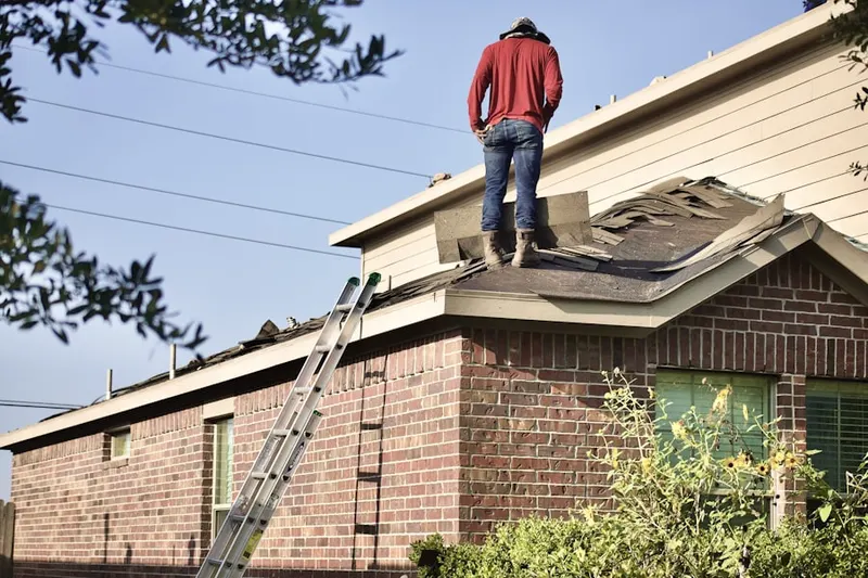 Professional roofer working on a residential roof in Buffalo Mills